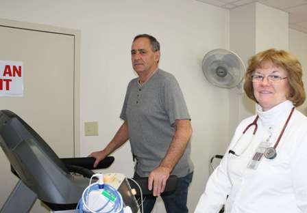 Cardiac Rehabilitation patient Mike Niday gets encouragement from Cardiac Nurse  Denise Sheston, RN. 