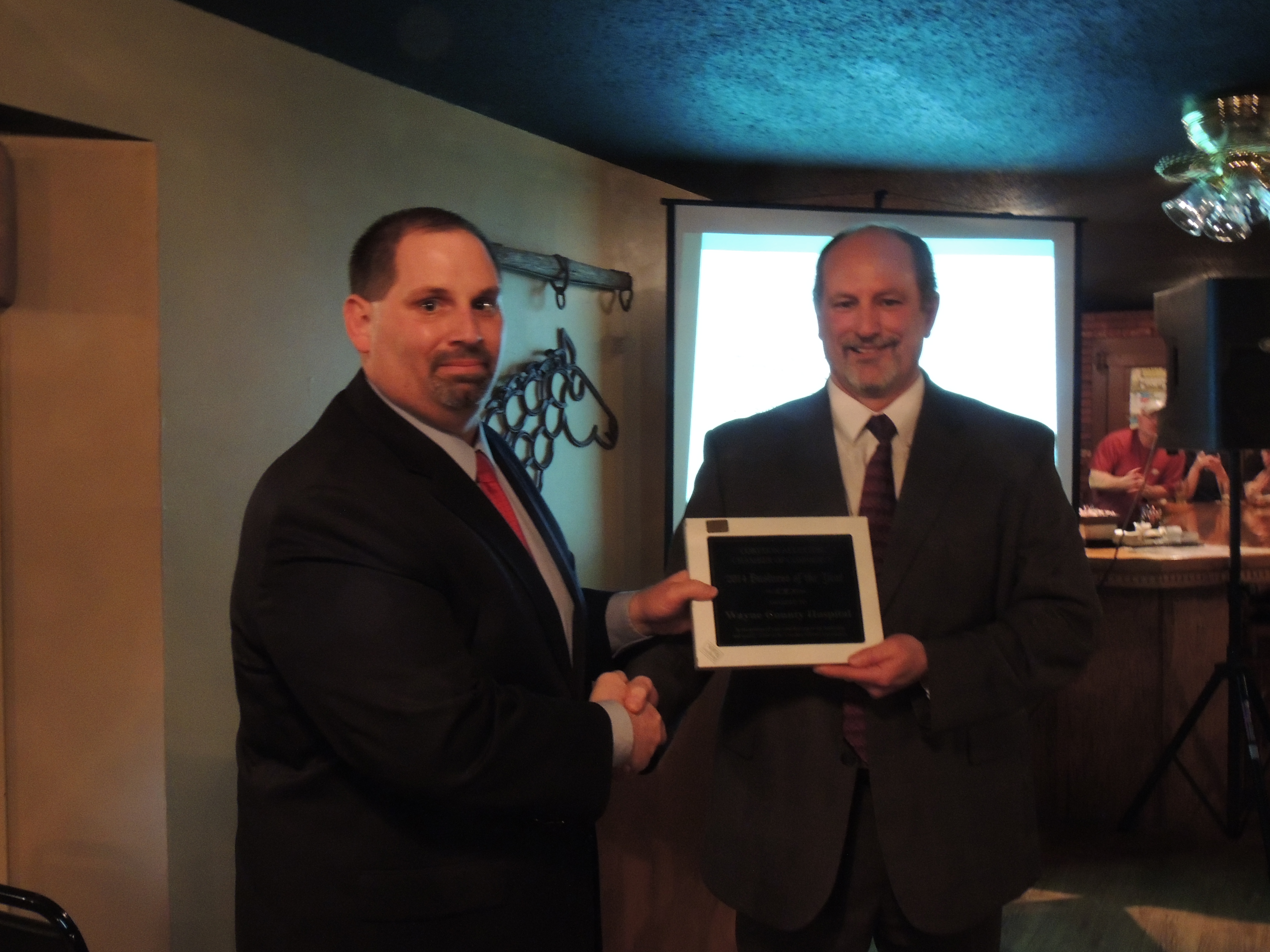 Mike Thomas, Associate Administrator WCHCS, accepts the Corydon/Allerton Chamber Business of the Year Award from Chamber Board member, Dave Daughton.